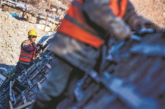 1月3日，房山區(qū)，工人正在雙泉河修筑堤壩。