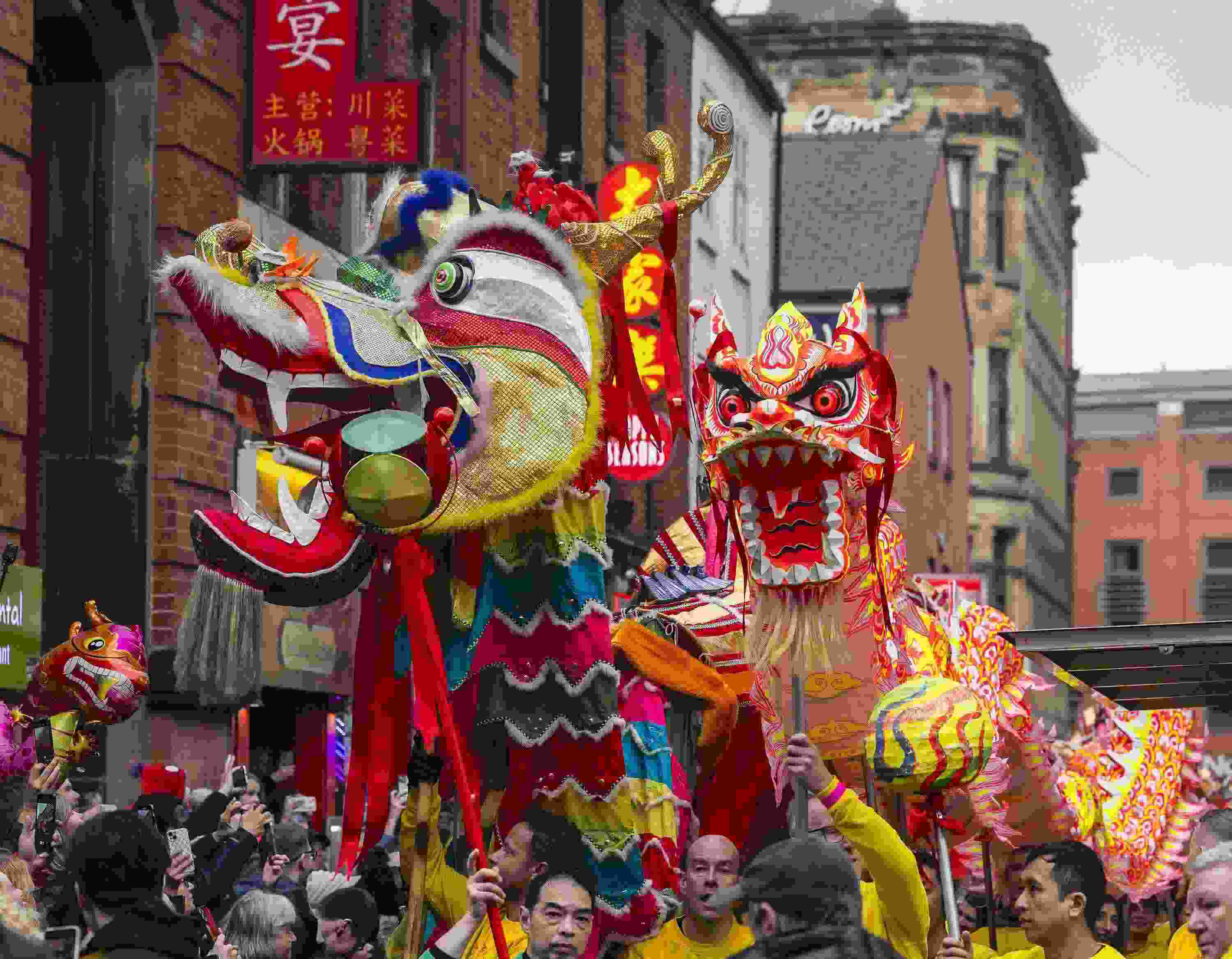 △ 當(dāng)?shù)貢r(shí)間2024年2月11日，英國曼徹斯特，表演者進(jìn)入中國城，參加中國農(nóng)歷龍年春節(jié)的慶?；顒?dòng)。