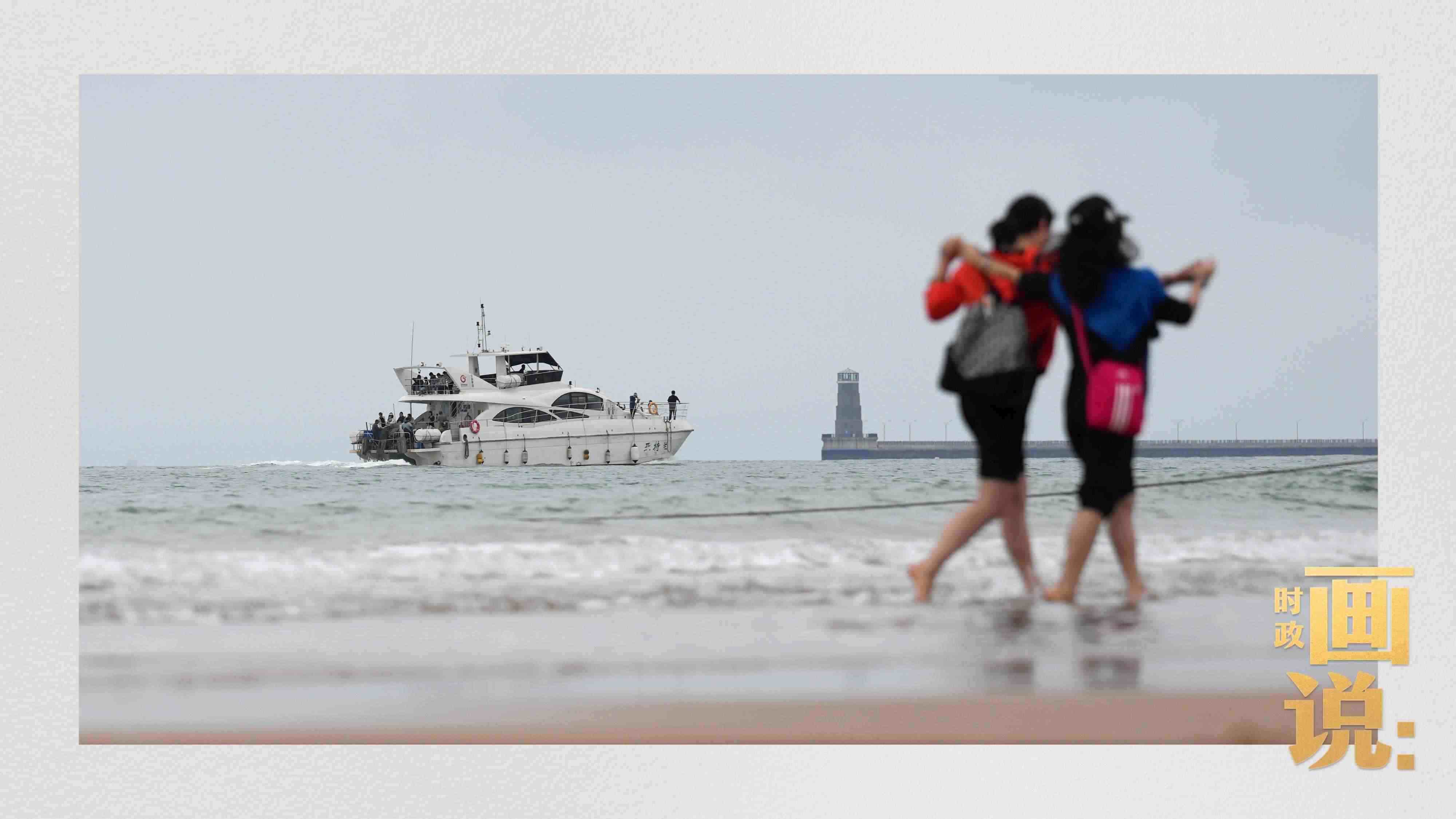 △日照陽光海岸綠道上的萬平口景區(qū)，一對游客在海浪中翩然起舞。