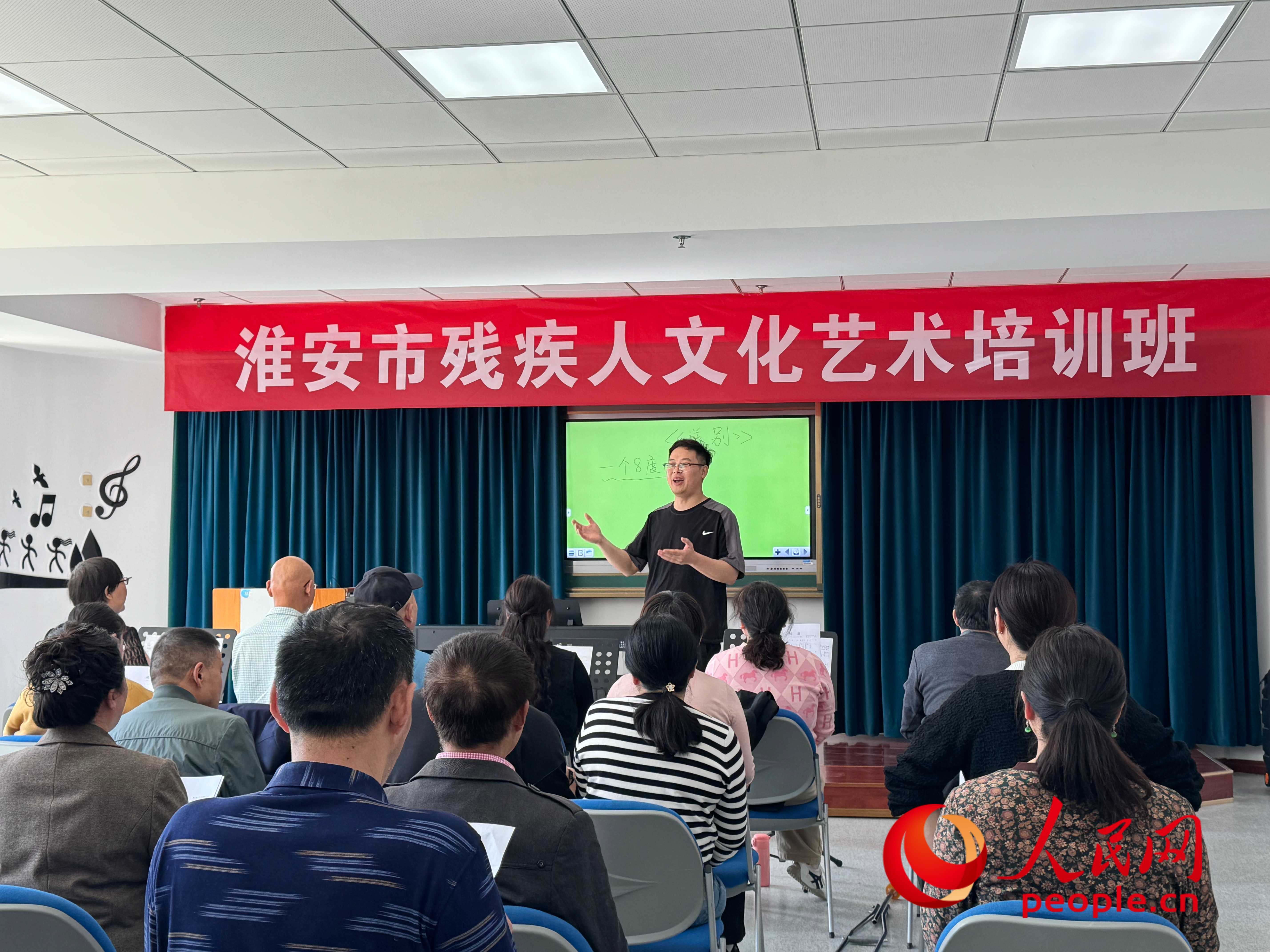在淮安市殘疾人文化藝術(shù)培訓(xùn)班上，聲樂(lè)老師在教殘疾人唱《送別》這首歌曲。人民網(wǎng) 周靜圓攝