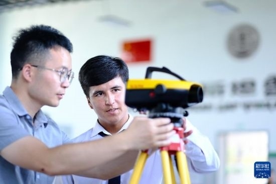 6月14日，在塔吉克斯坦首都杜尚別的魯班工坊，來自天津城市建設(shè)管理職業(yè)技術(shù)學(xué)院的老師（左）指導(dǎo)學(xué)生。新華社記者 鄭開君 攝