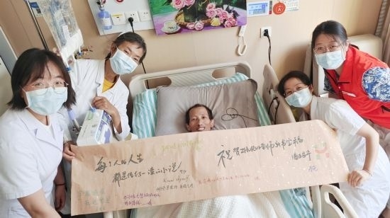7月26日，海淀醫(yī)院安寧療護(hù)科醫(yī)護(hù)團(tuán)隊(duì)為朱銳送來一條寫滿祝福的橫幅。（受訪者供圖）