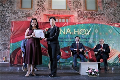 李雅芳向加比拉爾·塞迪略授予“拉美分社榮譽(yù)員工”稱號。主辦方供圖