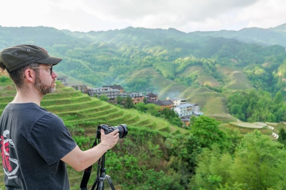 2025年年5月9日，廣西桂林，外國(guó)游客游覽龍脊梯田，在美景前駐足拍照。（圖片來(lái)源：視覺中國(guó)）