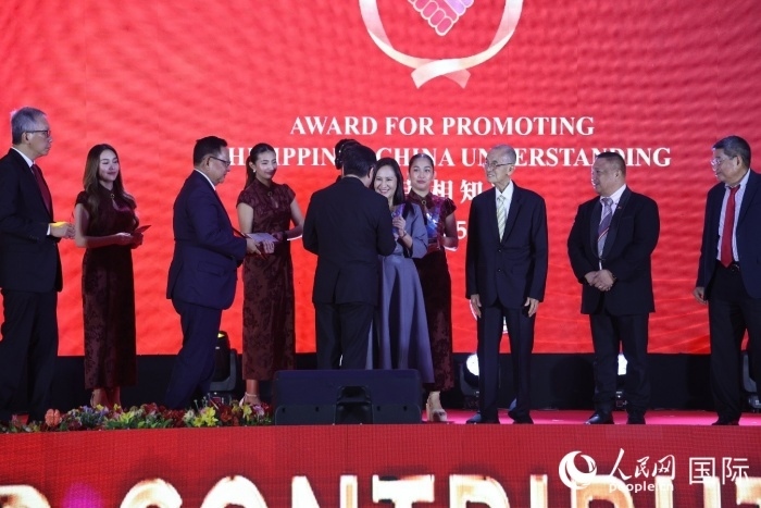 黃溪連大使給榮獲“重要貢獻獎”的奎松市市長喬伊·貝蒙蒂等人頒獎。人民網(wǎng)記者 樊帆攝